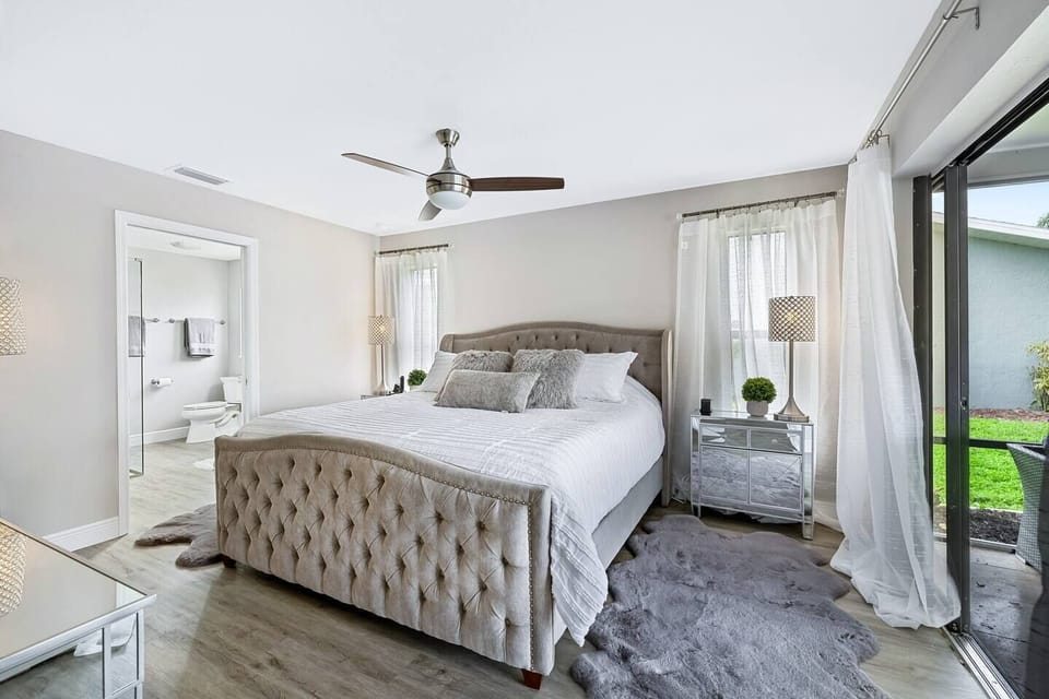Sun-drenched owner’s suite with custom sliding doors to the pool area, designed for rest, relaxation, and quiet mornings.