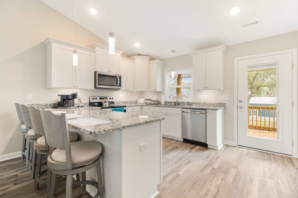 Fully equipped kitchen with a 4-barstool counter. Everything needed to cook you favorite meals!