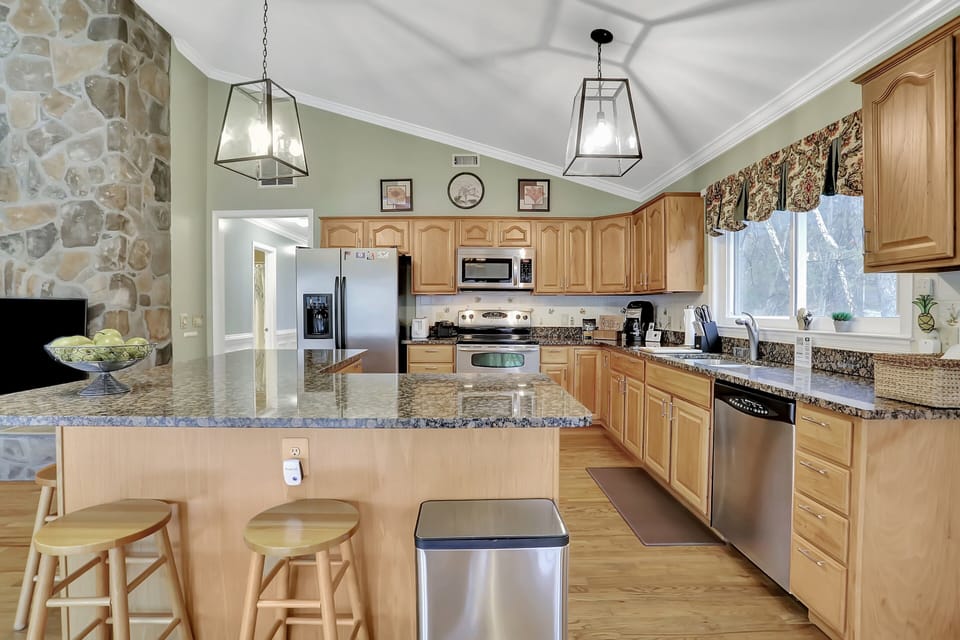 Open kitchen with stainless steel appliances.