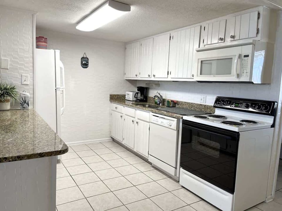 Fully stocked kitchen with everything you need for home-cooked meals by the beach.

