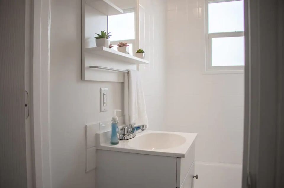 Clean, bright bathroom with white vanity and modern fixtures.