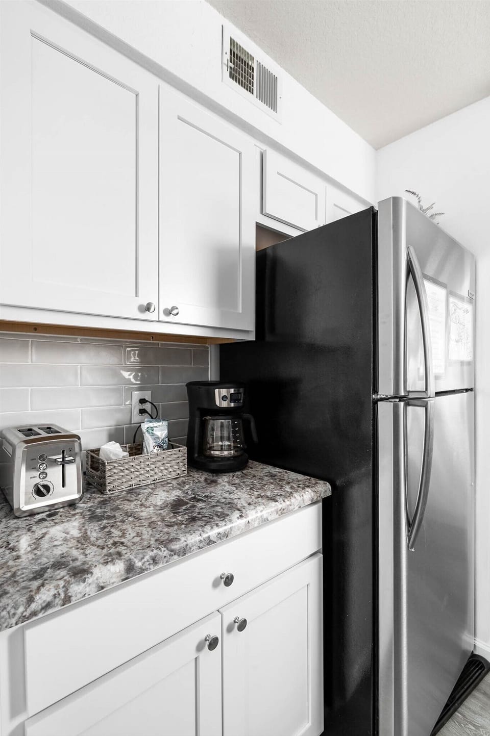 Kitchen with coffee maker and toaster (other appliances in the cabinet).