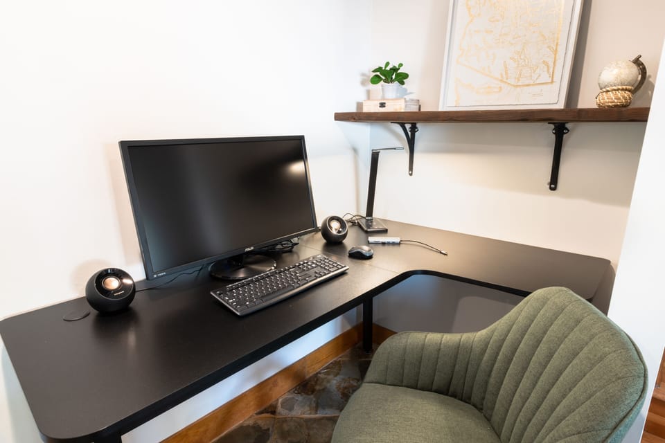 Dedicated office space with monitor and keyboard. 