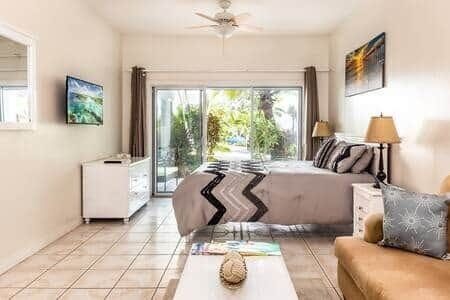 The living space with the patio in the background that leads to the pool.