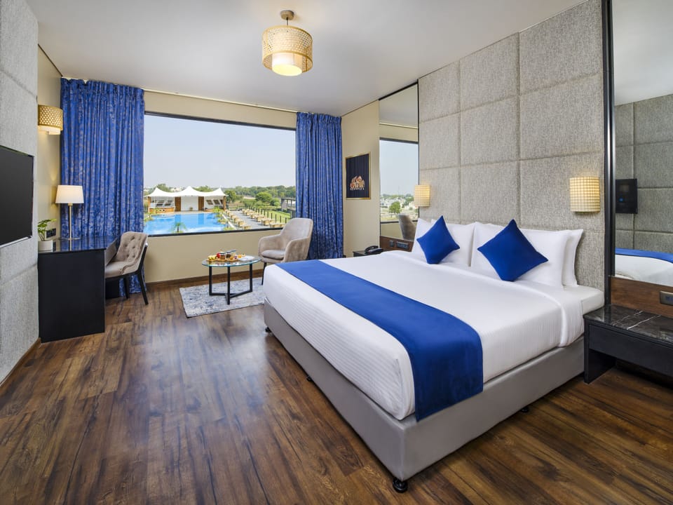 Deluxe Room, 1 King Bed, Pool View (Premium King) | In-room safe, laptop workspace, soundproofing, iron/ironing board