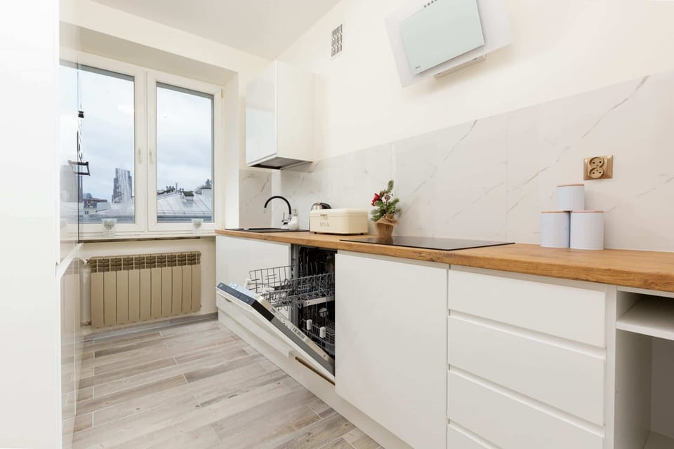 A fully equipped kitchen with ample counter space and functional appliances.
