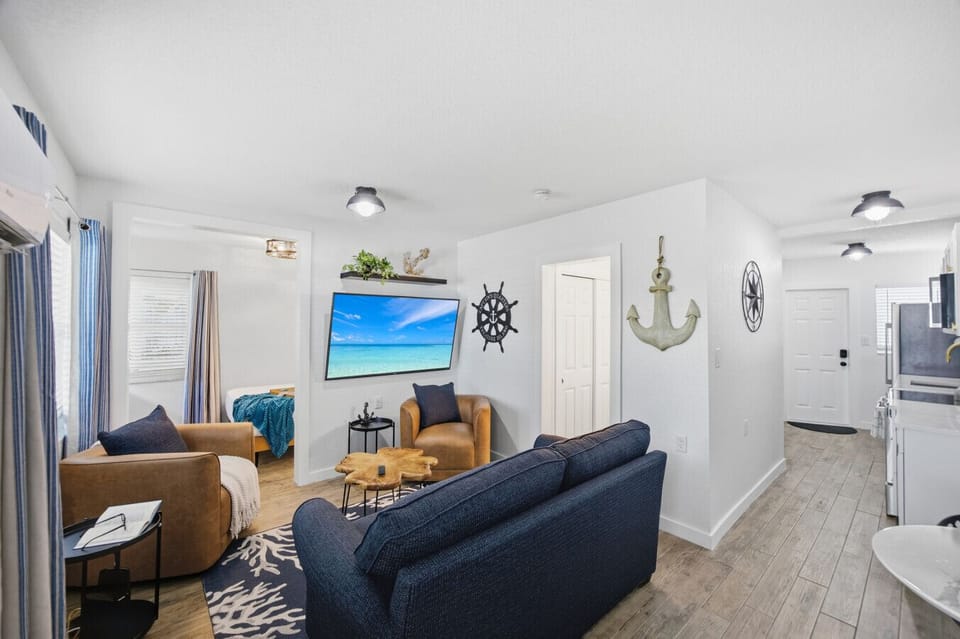 65 Inch TV Living Room: Modern decor meets beach vibes—relax and enjoy the stunning view!