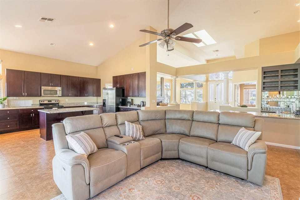 View of TV room, kitchen and bar