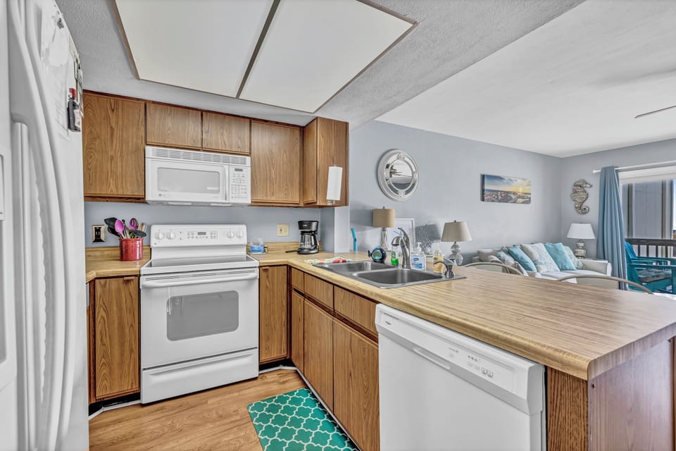 Full kitchen with fridge, dishwasher, stove and kitchen necessities.