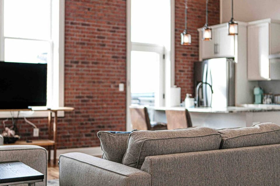 Living Room: Unwind in this modern space with exposed brick and stunning city views!