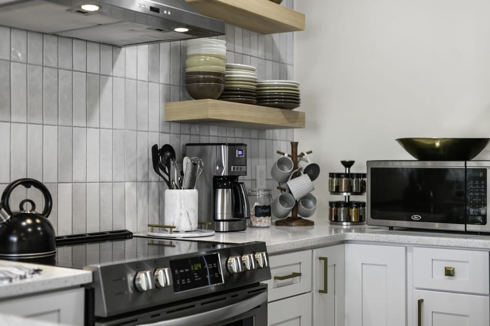 Electric stove + oven, drip coffee maker (coffee provided) and microwave.