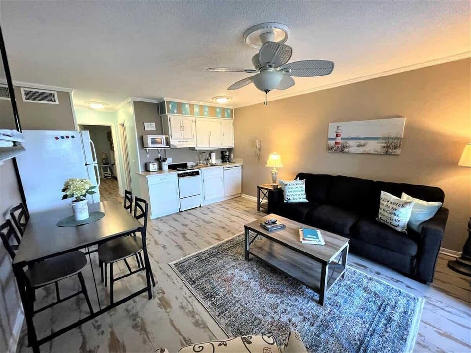 A bright and airy living area featuring stylish wood-plank flooring.