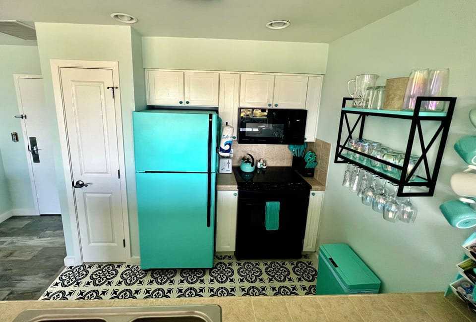 Kitchen w/fridge, stove, microwave, dishwasher, blender, knife set, pots & pans.
