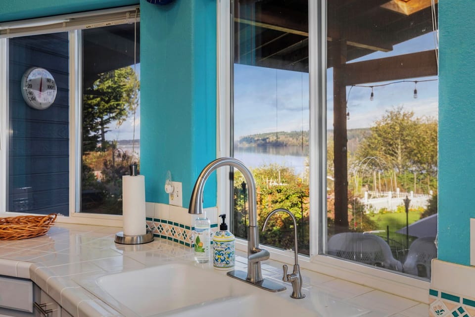 Wrap around counters with large windows providing garden and water views