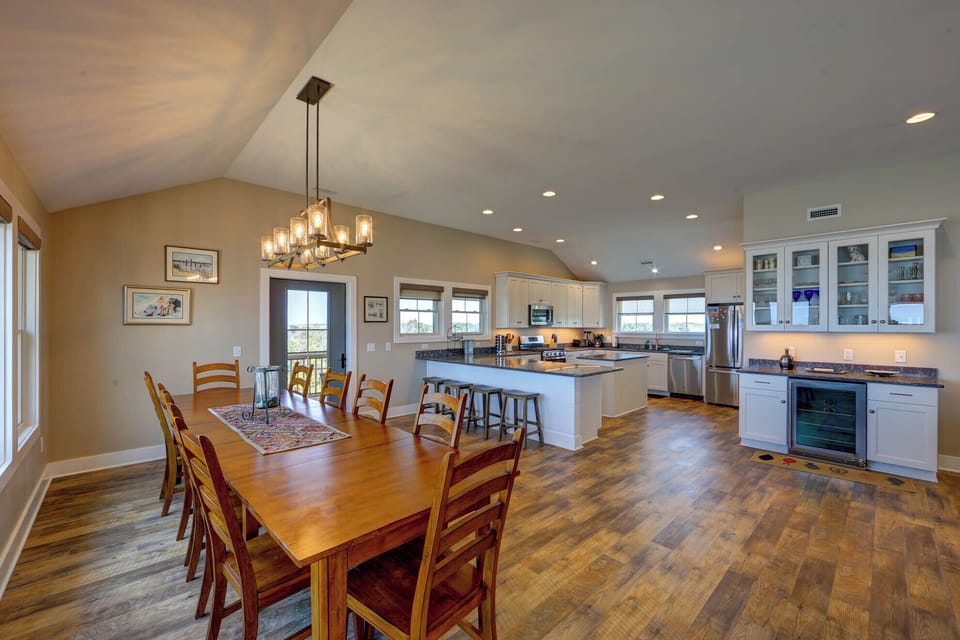 Your spacious open-concept living flows seamlessly from kitchen to dining, perfect for gathering with loved ones under warm pendant lighting.