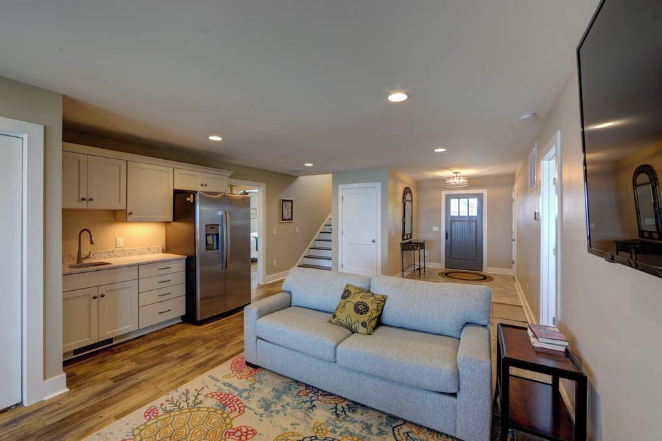 Step into this bright, open space where modern comfort meets home. Relax on the cozy sofa while dinner simmers in your fully-equipped kitchen.
