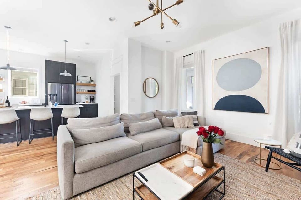 The open layout between the living room and kitchen invites everyone to join in the conversation.