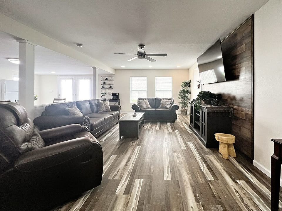 Living Room with love seat, couch and recliner to sit and relax on.