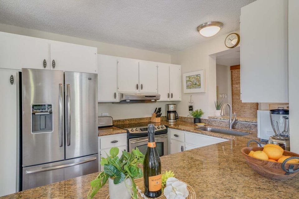 Kitchens shine with granite and steel, bowls of oranges brightening the counter.