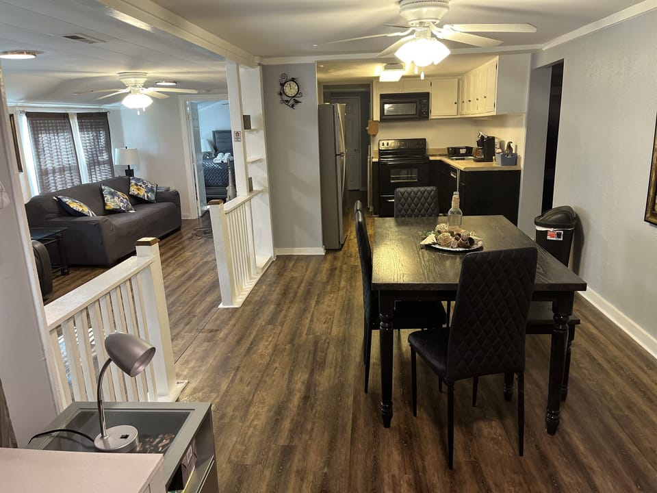 Dinning room has seating for 6 in a open concept dining spaces. Converse with your group in the living room while you eat in the dining room. Board games are also stored in the dinning room.