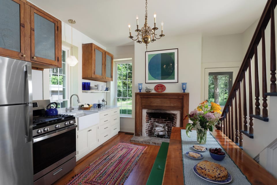 Kitchen is well-equipped with new appliances and historic pie safe cupboards.
