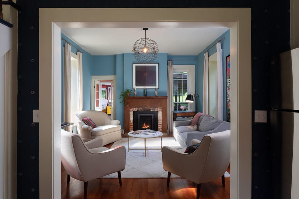 Living room with historic details and relaxed elegance. Gas fireplace.
