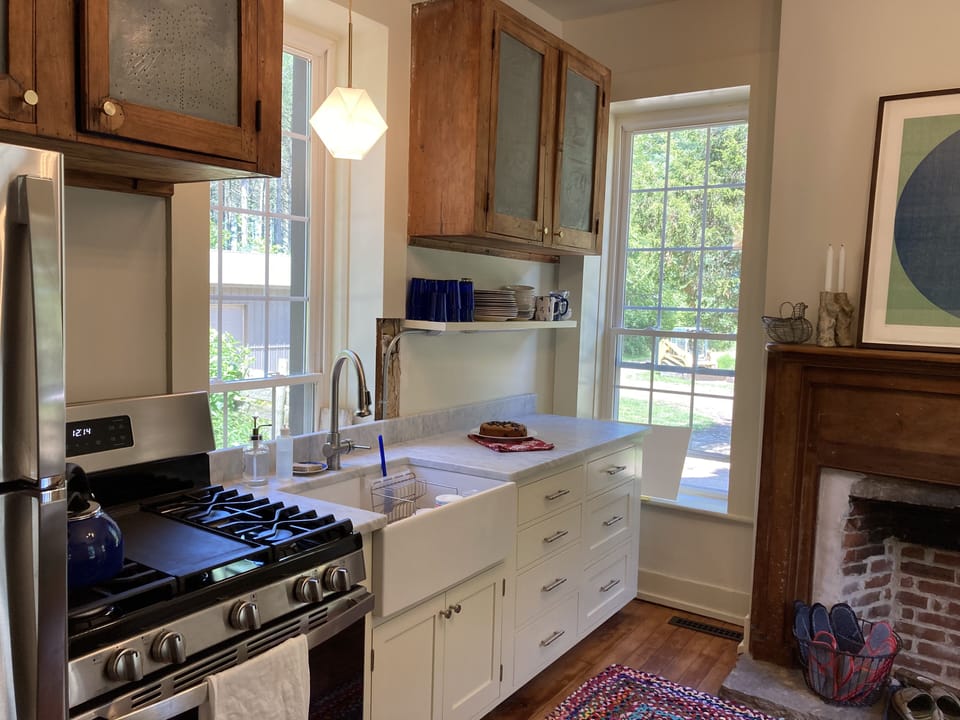 Beautiful little kitchen with Carrera marble counter.