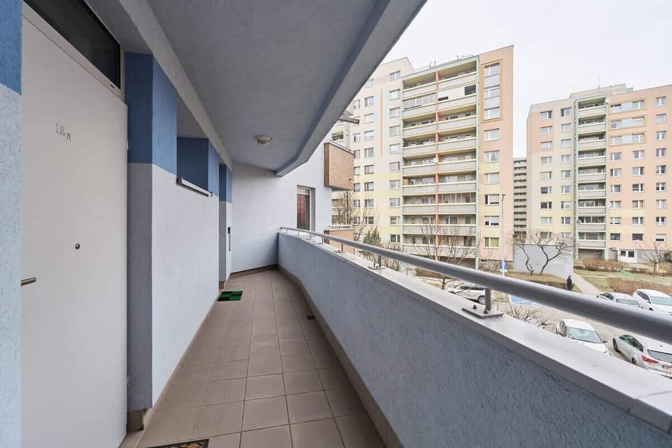 A spacious balcony with a view of the surrounding residential area.
