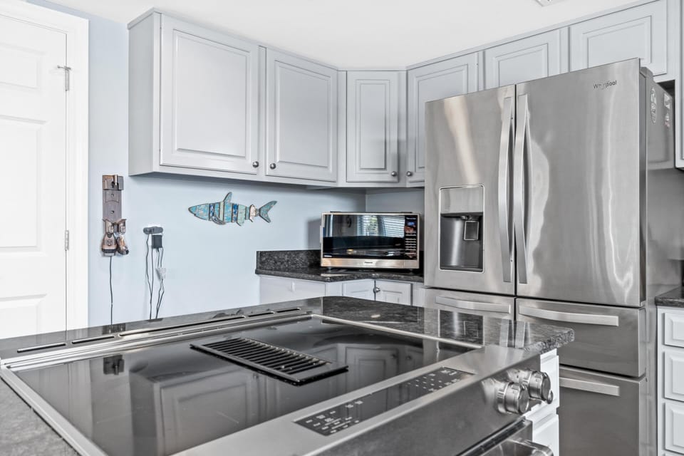 full kitchen with granite countertops and stainless steel appliances. 