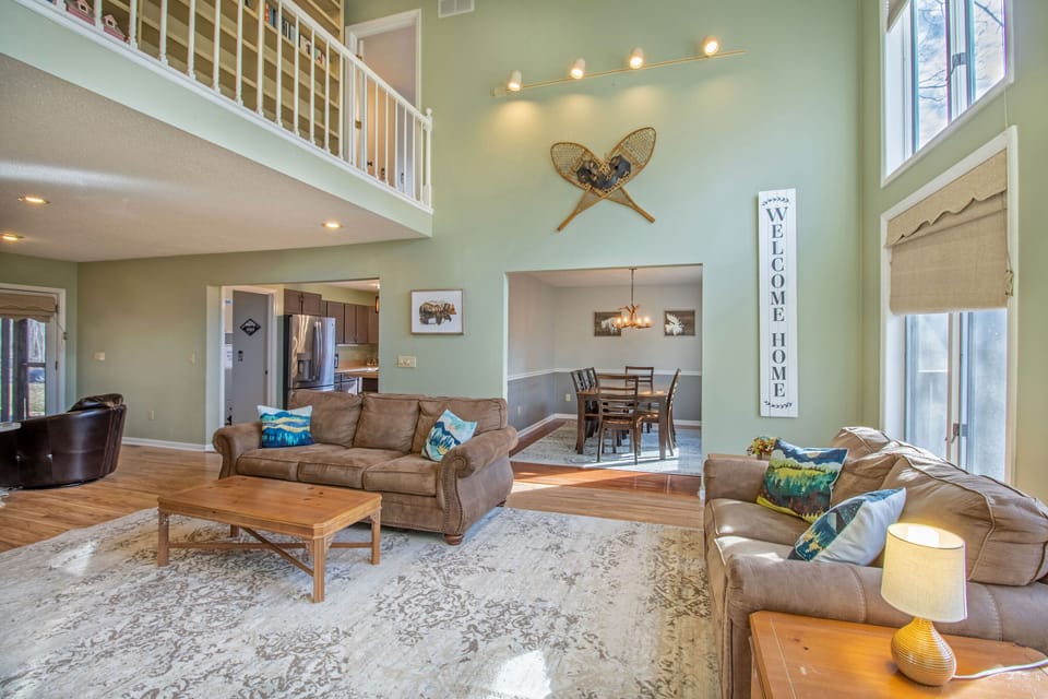 Living area with tall ceilings and expansive windows