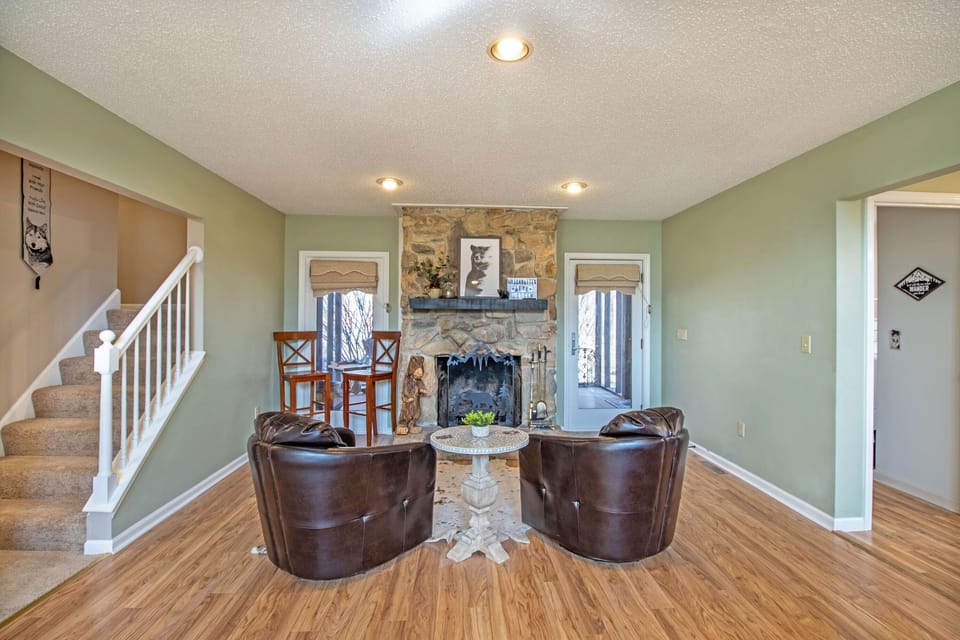 Additional living area seating around the stone fireplace
