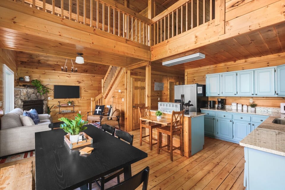 Fully-stocked kitchen with high-top seating for two and a large dining table with seating for 6