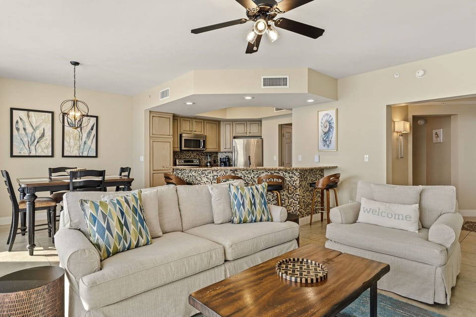 Settle into your open-concept living space where coastal comfort meets modern convenience, complete with full kitchen and dining.