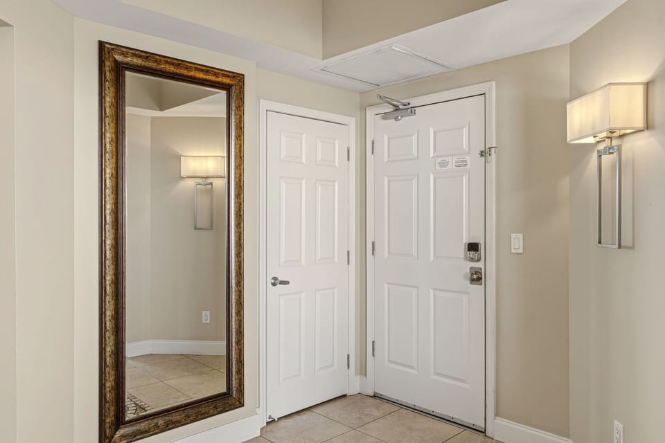 Step into your welcoming entryway with elegant lighting and a full-length mirror perfect for last-minute checks before heading out.
