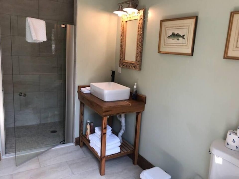 Large marble tile bathroom with accessible shower