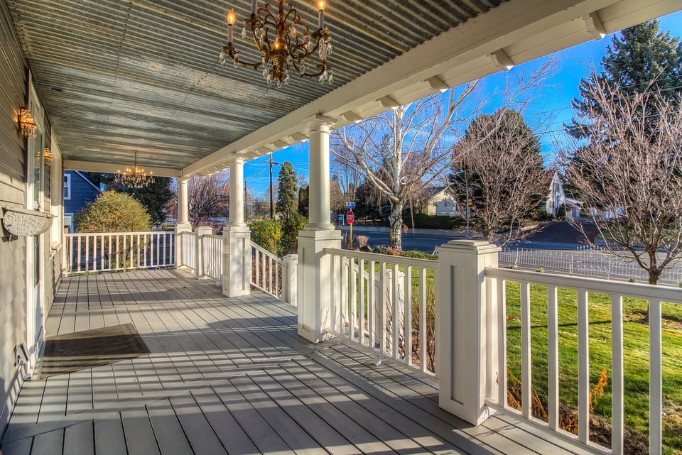 Covered front porch with chandelier lighting.