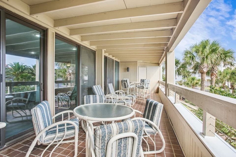 - Stylish balcony with multiple seating areas and palm framed views
- Glass topped tables and cushioned chairs make outdoor dining a treat
- Perfect for morning coffee, evening cocktails, or simply relaxing