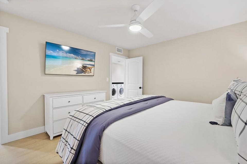 Inviting maser bedroom with king bed and TV