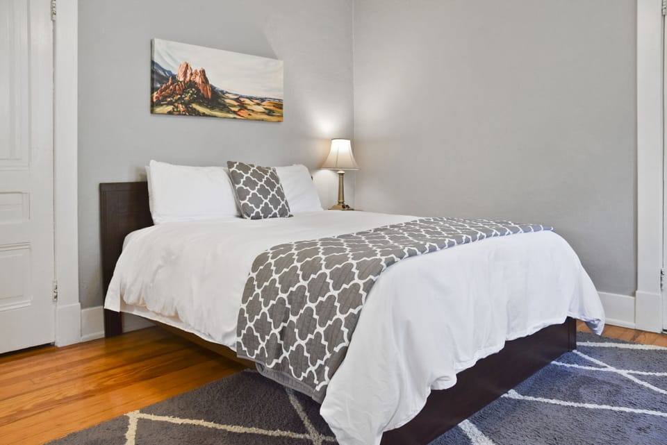 This primary bedroom features a queen sized bed and a pass-through to bathroom.