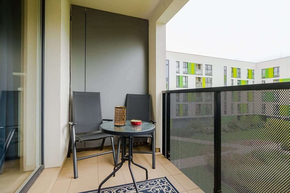 A private balcony with outdoor furniture, offering a peaceful spot to enjoy a coffee or the surrounding view.