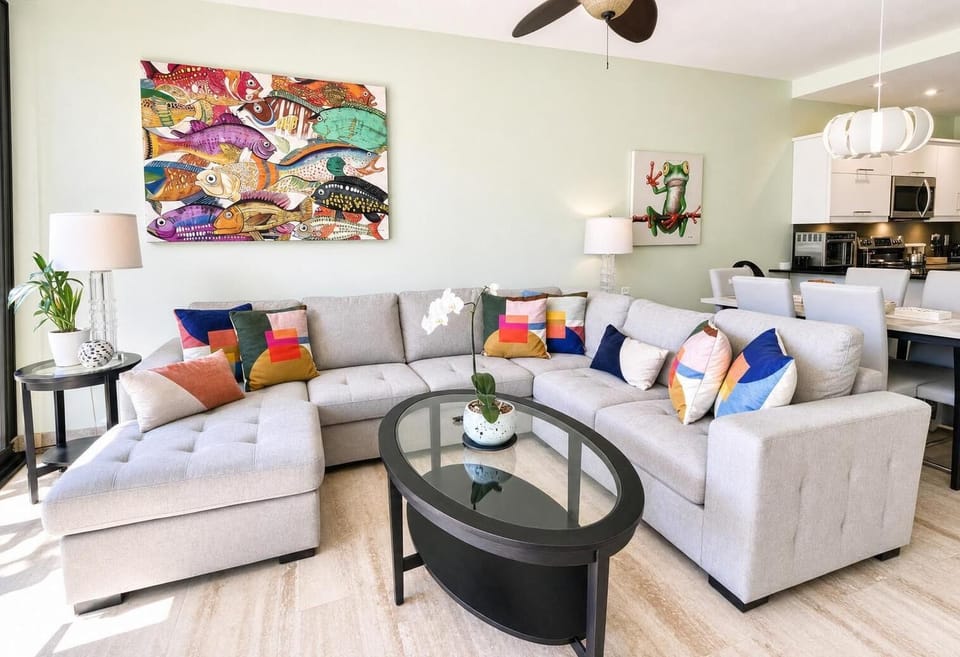 Living room with upholstered furniture and a dining area