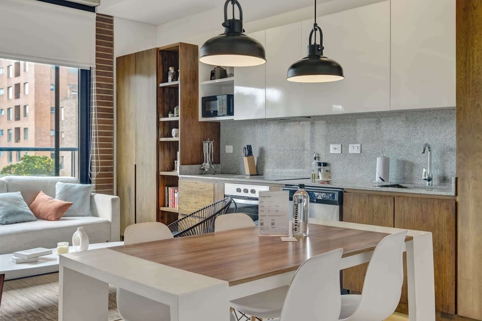 Gather around the dining table while enjoying the modern open kitchen.