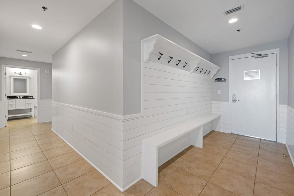 An organizer's dream come true!  This 10+ foot long hallway built-in provides plenty of storage to hang your beach bags, put up your keys on the custom "Panama City" key holder and store your flip flops.