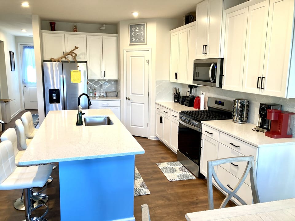 Kitchen has stainless steel appliances, basic dishware, blender, mixer and more
