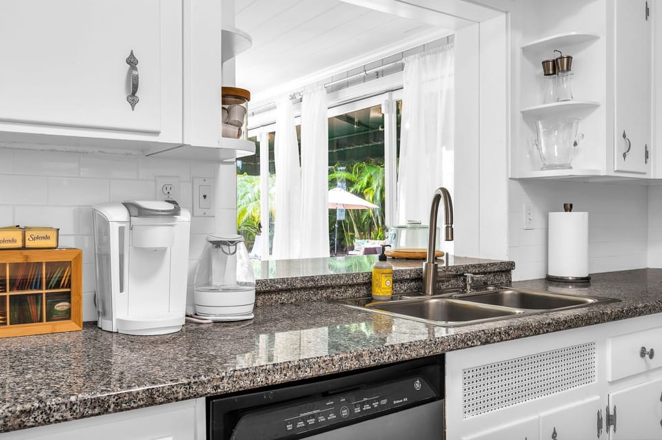 The kitchen has a unique antique feel with the original cabinetry. Upgraded with new flooring and black granite countertops. Fully equipped with everything you need to create a lovely meal for friends and family.