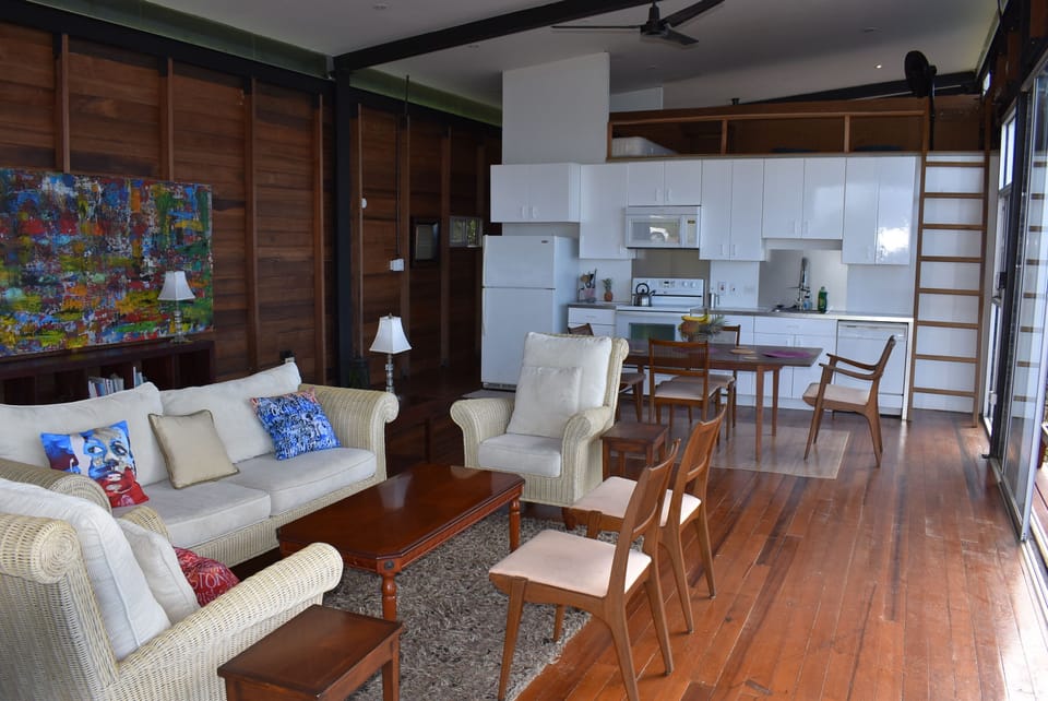 living room dining room area with a sleeping loft. accessible by ladder only 