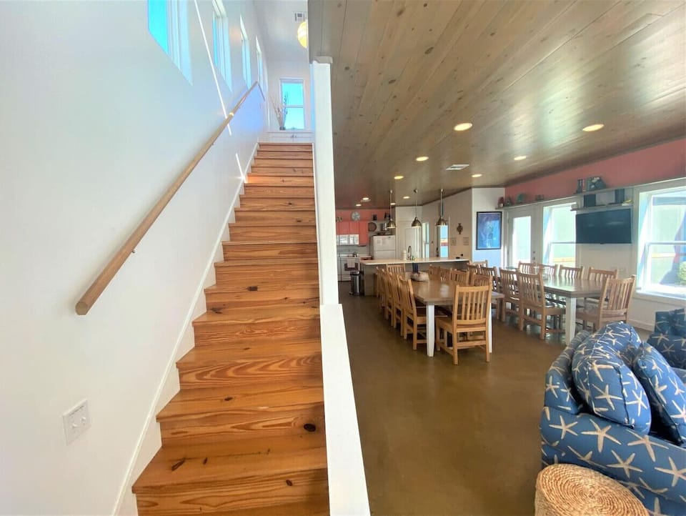 Stairs leading to the second floor with open-concept living and dining below.