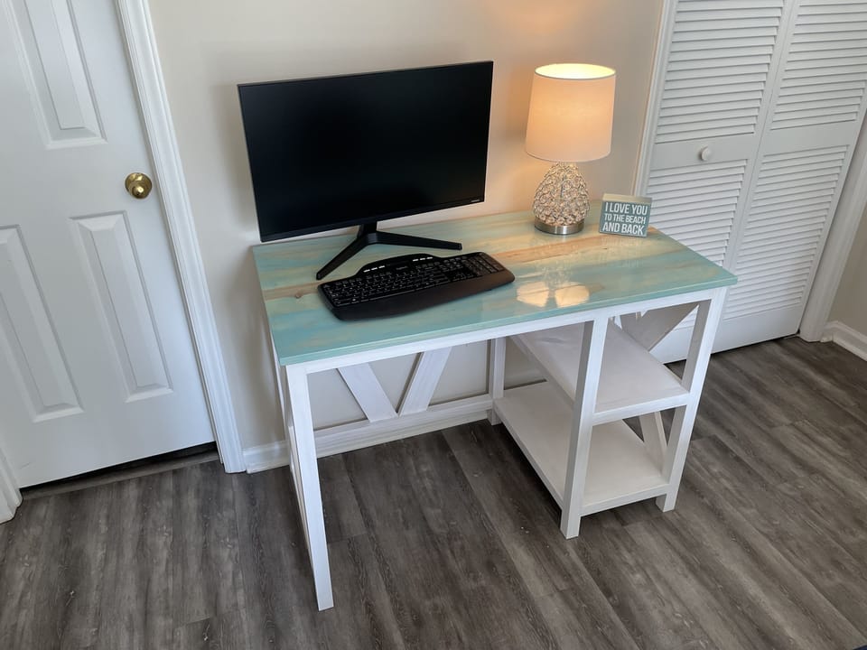 Dedicated workspace in the master bedroom, 27 inch monitor connects via HDMI