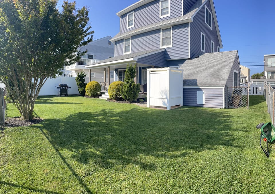 rear fenced yard with shower