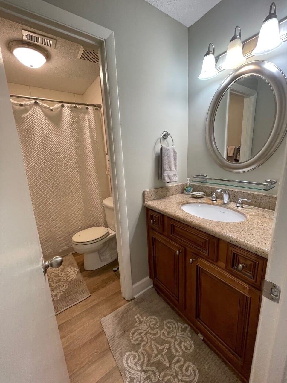 One bath with vanity area. A hairdryer and towels are provided.